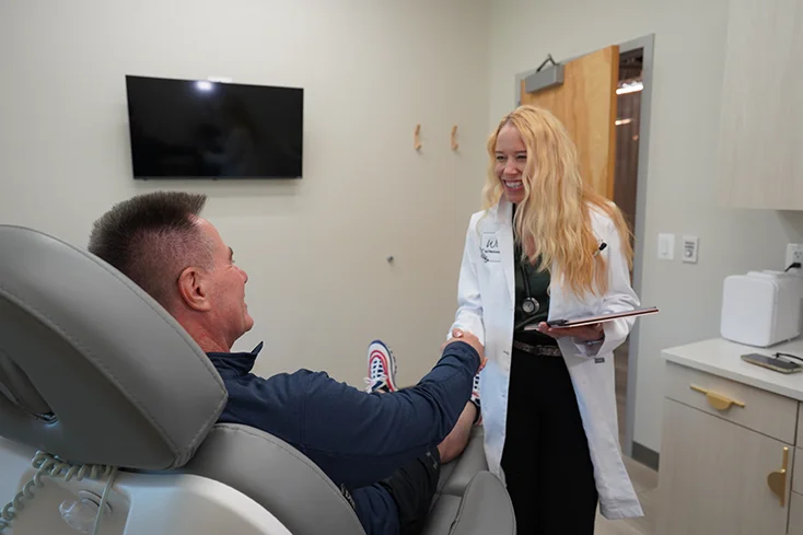 Dr. Meg greeting a male patient at YOUR.Life inside the Newtown Athletic Club
